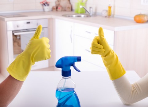 A cleaner sanitising shared kitchen and washroom areas in a Lambeth workplace