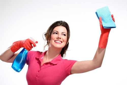 Local cleaning technician assessing a stain on a sofa in Lambeth
